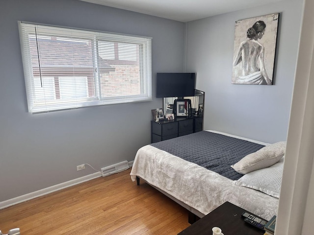 9911 Kedvale Ave, Skokie, IL 60076 - bedroom with baseboards, wood finished floors, and visible vents