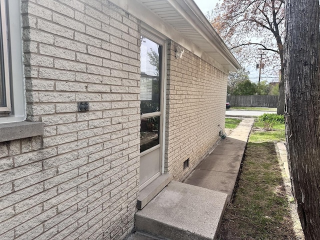 9911 Kedvale Ave, Skokie, IL 60076 - view of side of home featuring brick siding, crawl space, and fence