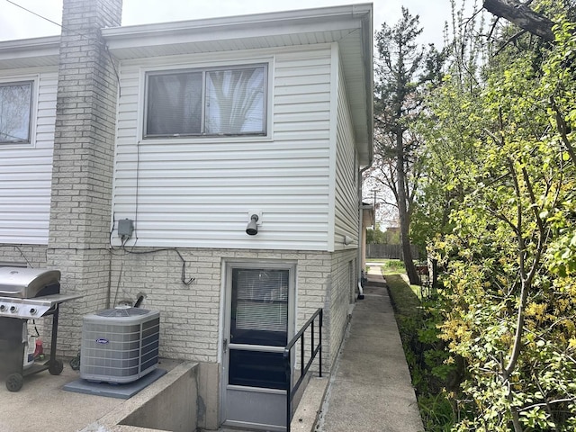 9911 Kedvale Ave, Skokie, IL 60076 - view of side of property with brick siding and cooling unit