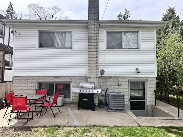 9911 Kedvale Ave, Skokie, IL 60076 - back of property with cooling unit, a chimney, and a patio area