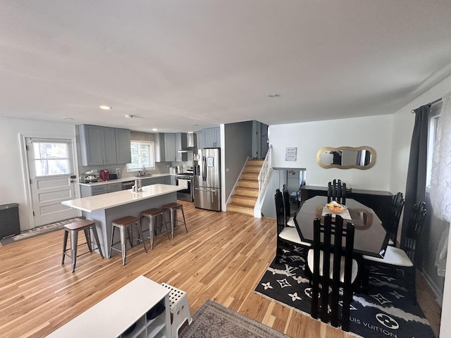 9911 Kedvale Ave, Skokie, IL 60076 - dining room with recessed lighting, stairway, and light wood finished floors