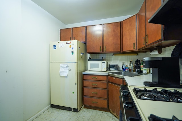 400 E Randolph St Unit 906, Chicago, IL 60601 - kitchen featuring a sink, light countertops, baseboards, under cabinet range hood, and white appliances