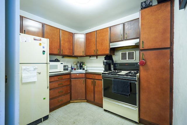 400 E Randolph St Unit 906, Chicago, IL 60601 - kitchen with brown cabinetry, backsplash, light floors, under cabinet range hood, and white appliances
