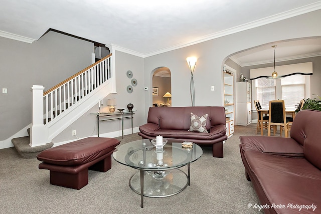 living area featuring crown molding, arched walkways, and stairs
