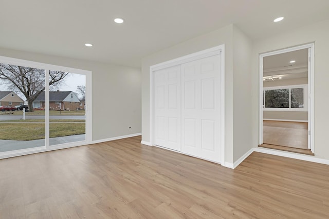 unfurnished bedroom with light wood-type flooring, recessed lighting, and baseboards