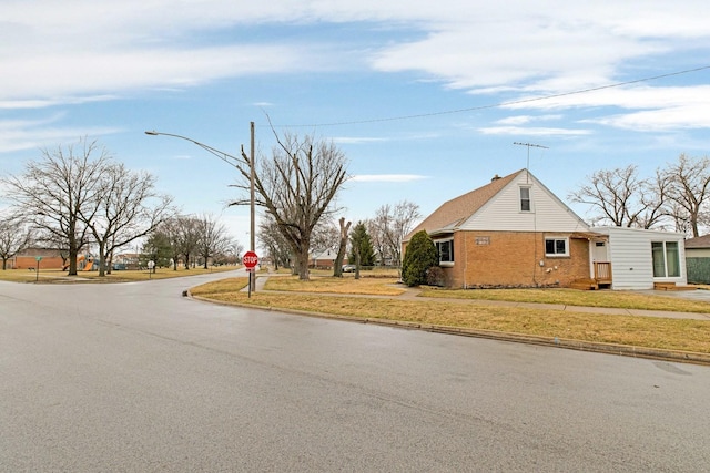 view of street featuring traffic signs, street lights, and curbs