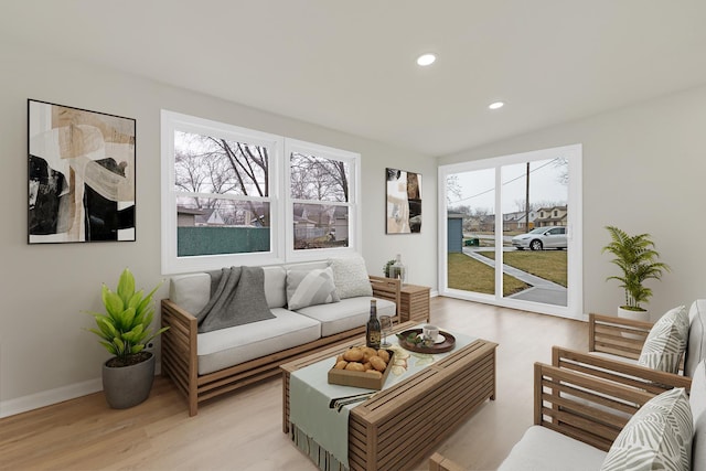 living room featuring recessed lighting, baseboards, and light wood-style flooring