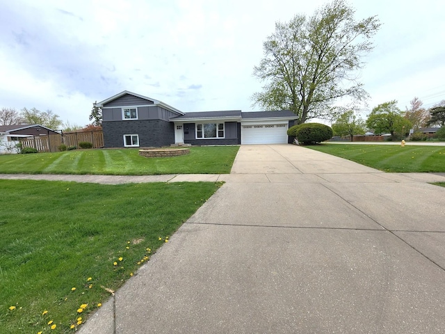 tri-level home with fence, an attached garage, driveway, and a front lawn