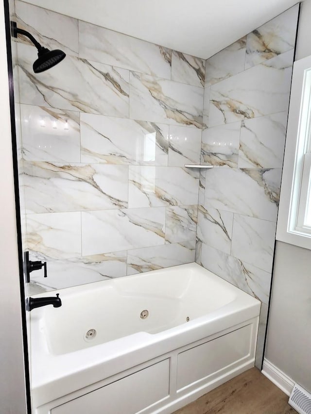 full bath with visible vents, a combined bath / shower with jetted tub, and wood finished floors