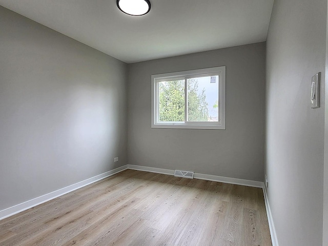 spare room with visible vents, baseboards, and light wood-type flooring
