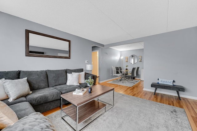 9960 Franchesca Ct Unit 2C, Orland Park, IL 60462 - living room featuring wood finished floors, baseboards, and a textured ceiling