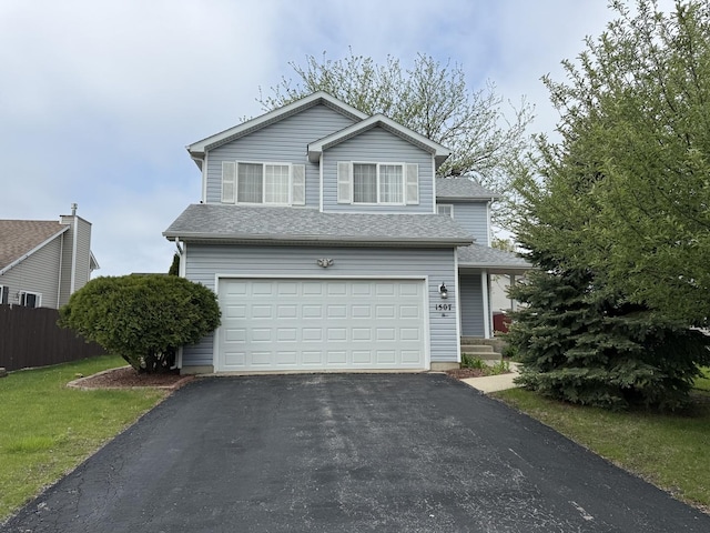 traditional-style home featuring fence, an attached garage, roof with shingles, and aphalt driveway