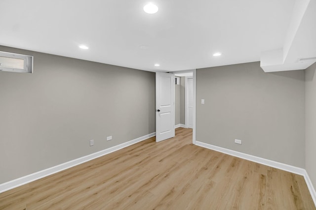 finished below grade area featuring baseboards, recessed lighting, and light wood-style flooring
