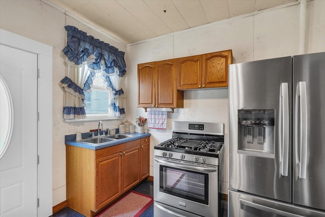 kitchen featuring appliances with stainless steel finishes, brown cabinetry, and a sink