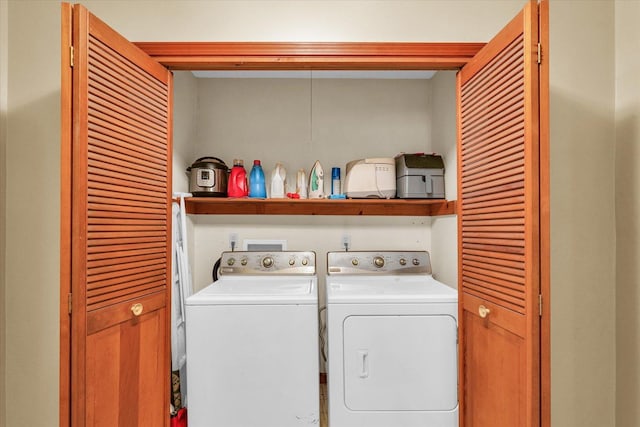 clothes washing area featuring separate washer and dryer and laundry area