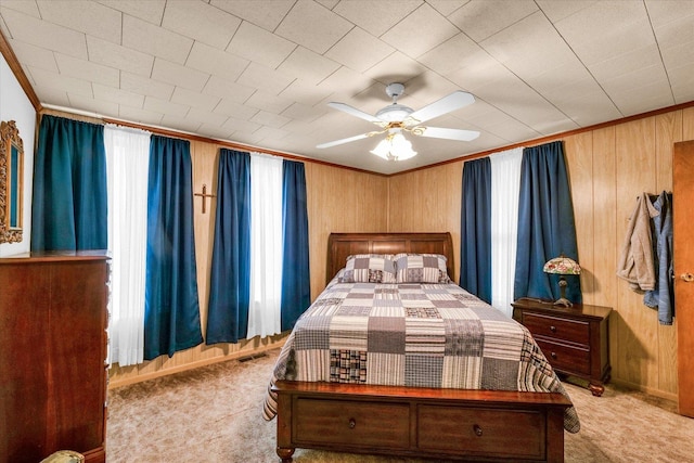 bedroom with crown molding, carpet flooring, wood walls, and visible vents