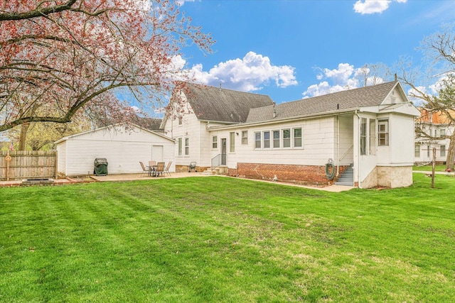 rear view of house with fence, a patio, roof with shingles, entry steps, and a yard