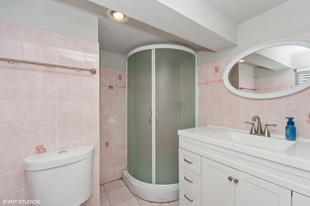 full bath with tile walls, tile patterned flooring, a stall shower, vanity, and toilet