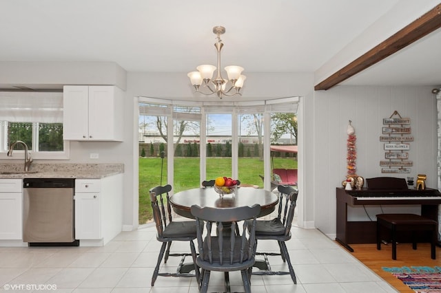 dining room featuring light tile patterned floors, a notable chandelier, and a wealth of natural light