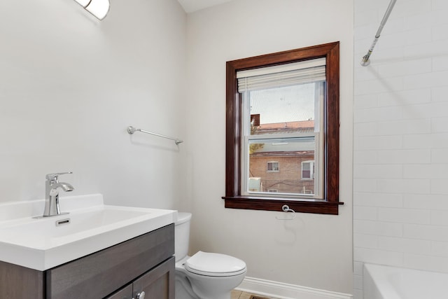 full bathroom with toilet, baseboards, vanity, and shower / bath combination