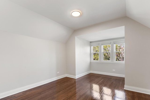 bonus room featuring vaulted ceiling, wood finished floors, and baseboards