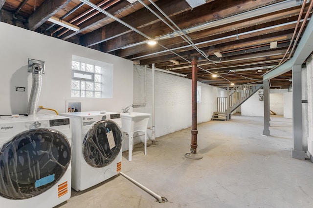 below grade area with independent washer and dryer, stairs, and a sink
