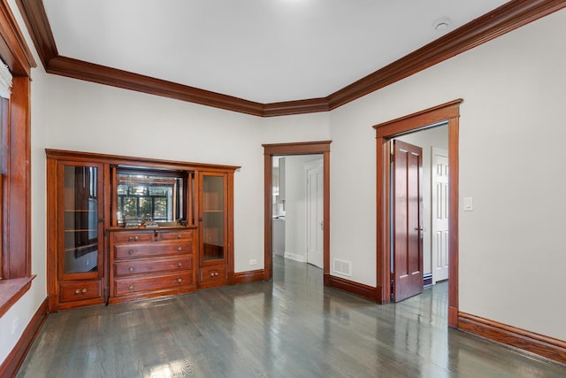 unfurnished room with ornamental molding, dark wood-style flooring, baseboards, and a smoke detector