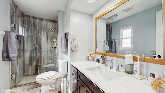 full bathroom with a shower stall, toilet, and vanity