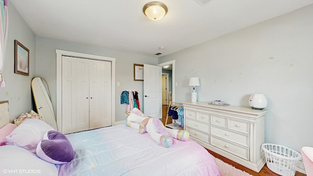 bedroom with a closet and light wood finished floors