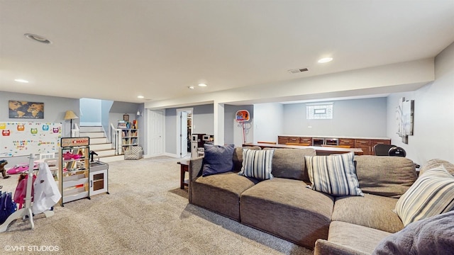 living area with recessed lighting, light colored carpet, and stairway