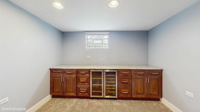 bar with beverage cooler, baseboards, light carpet, and recessed lighting