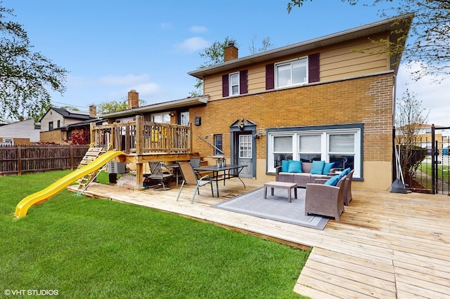 back of property featuring a playground, a chimney, brick siding, and outdoor lounge area