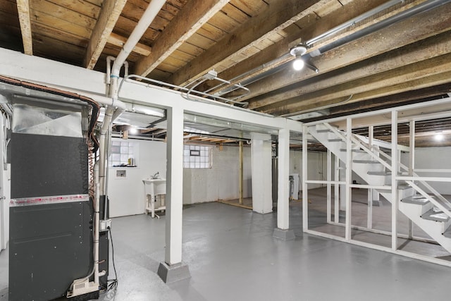 basement with stairway and heating unit