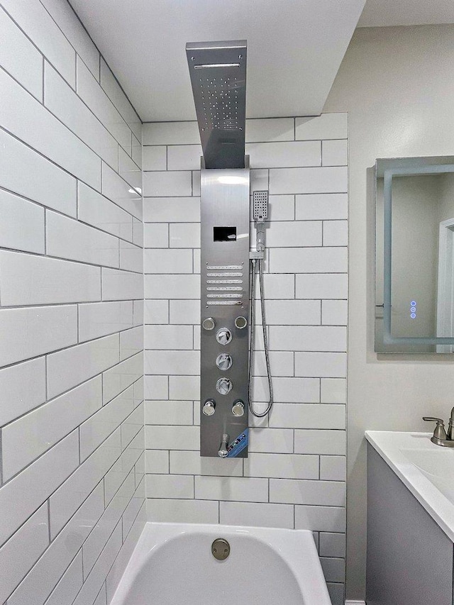 bathroom featuring shower / bath combination and vanity