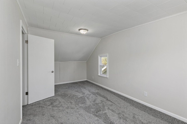 additional living space featuring baseboards, carpet flooring, and lofted ceiling