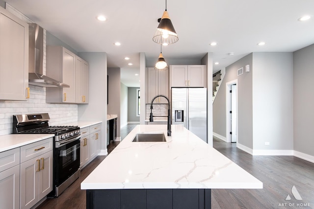 6908 26th St, Berwyn, IL 60402 - kitchen featuring a sink, stainless steel appliances, tasteful backsplash, a center island with sink, and wall chimney exhaust hood