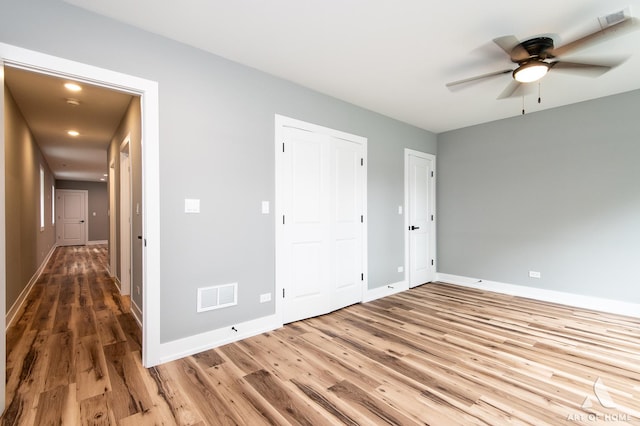 6908 26th St, Berwyn, IL 60402 - unfurnished bedroom with baseboards, visible vents, and wood finished floors