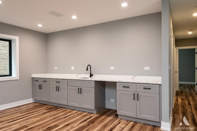 6908 26th St, Berwyn, IL 60402 - kitchen with light wood-type flooring, gray cabinets, visible vents, and a sink
