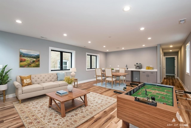 6908 26th St, Berwyn, IL 60402 - playroom featuring light wood-style floors, a wealth of natural light, baseboards, and recessed lighting