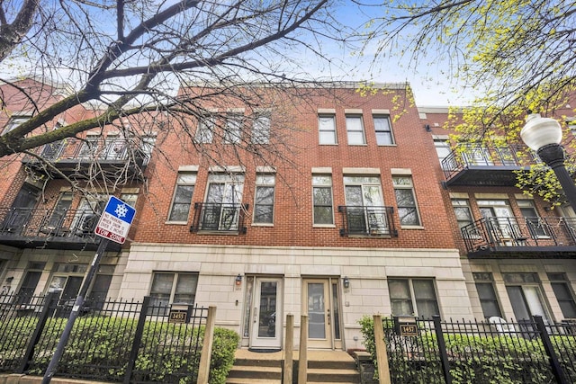 1455 S Halsted St, Chicago, IL 60607 - view of front facade with brick siding and a fenced front yard