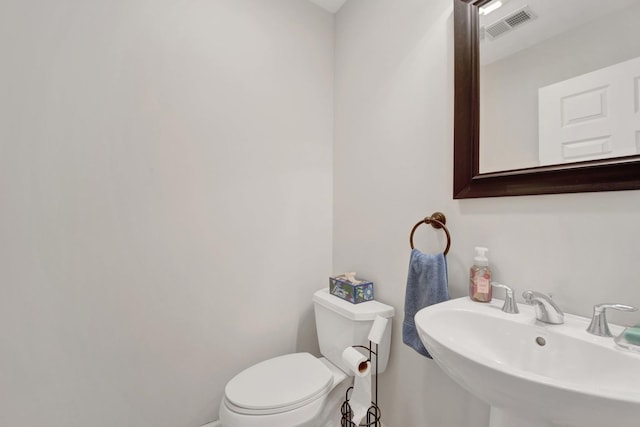 1455 S Halsted St, Chicago, IL 60607 - bathroom featuring a sink, toilet, and visible vents