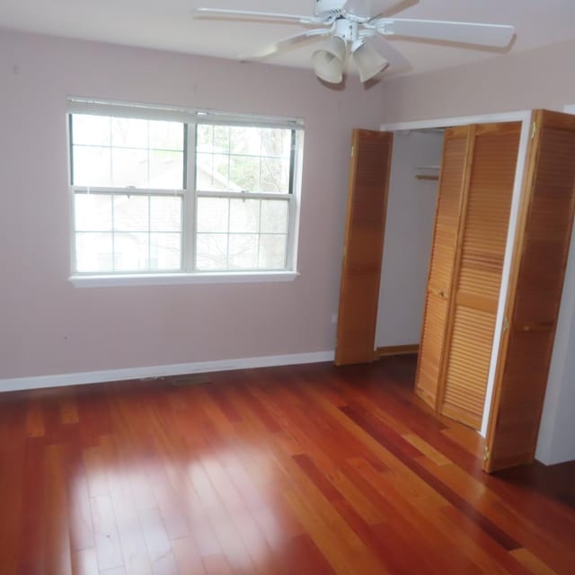 457 N Cambridge Dr Unit 457, Palatine, IL 60067 - unfurnished bedroom with baseboards, a ceiling fan, and wood finished floors