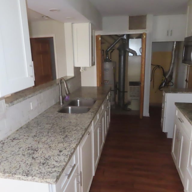 457 N Cambridge Dr Unit 457, Palatine, IL 60067 - kitchen featuring light stone countertops, dark wood finished floors, a sink, white cabinets, and water heater