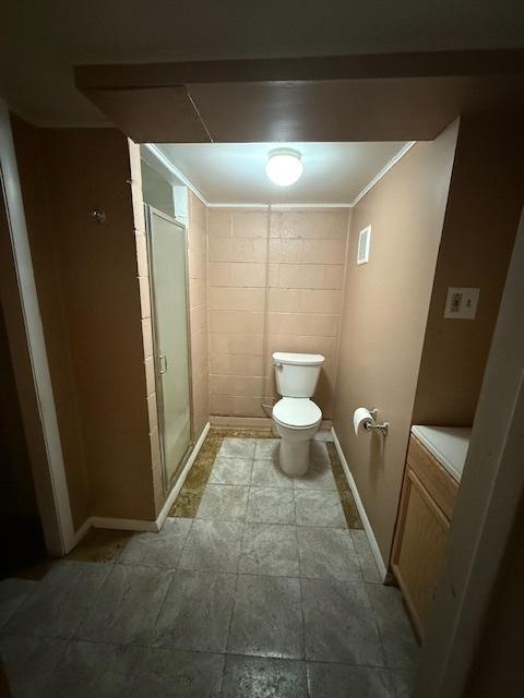 1304 Price Ave, Calumet City, IL 60409 - bathroom featuring baseboards, a stall shower, and toilet