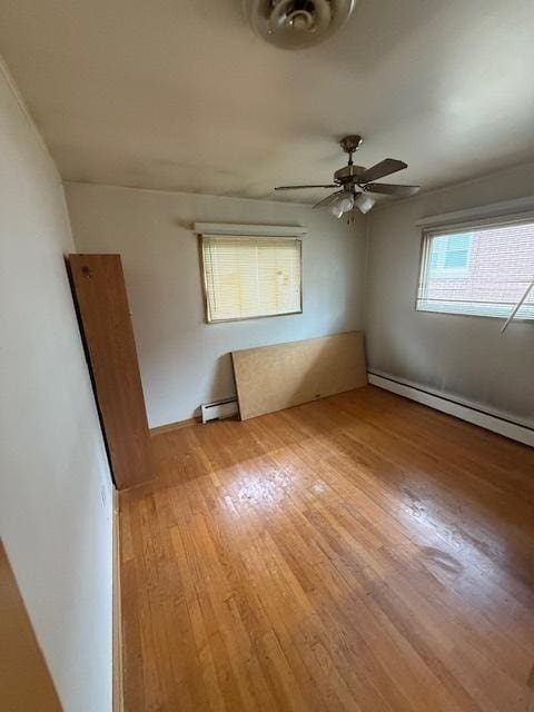 1304 Price Ave, Calumet City, IL 60409 - unfurnished room featuring a ceiling fan, baseboard heating, and light wood-style flooring