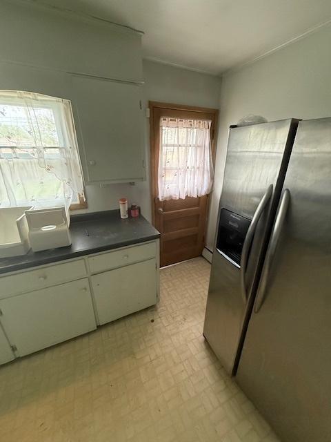 1304 Price Ave, Calumet City, IL 60409 - kitchen with white cabinetry, dark countertops, and stainless steel fridge with ice dispenser