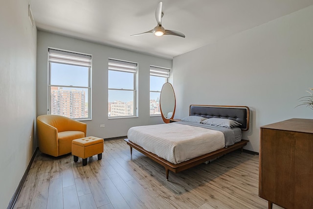 77 S Evergreen Ave Unit 1004, Arlington Heights, IL 60005 - bedroom featuring light wood-style floors, baseboards, and ceiling fan