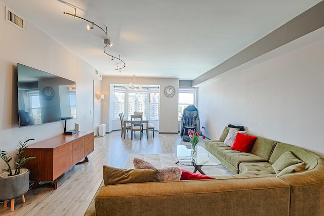 77 S Evergreen Ave Unit 1004, Arlington Heights, IL 60005 - living room featuring a chandelier, light wood-type flooring, and track lighting