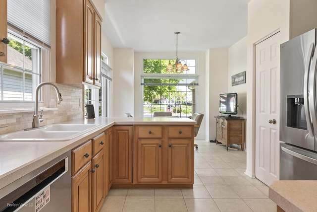 36225 N Goldspring Ct, Gurnee, IL 60031 - kitchen with appliances with stainless steel finishes, a sink, light countertops, and a chandelier