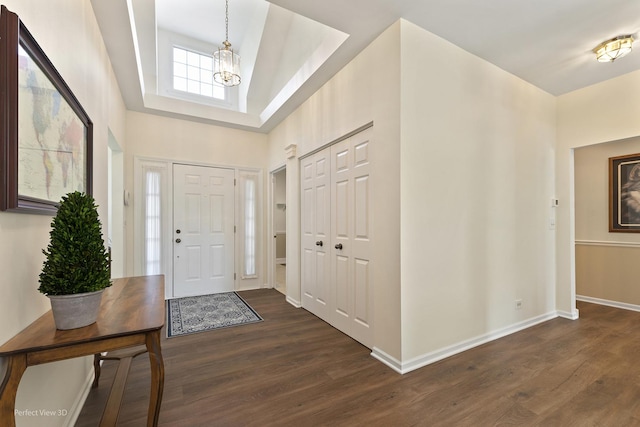 36225 N Goldspring Ct, Gurnee, IL 60031 - entryway featuring a chandelier, dark wood finished floors, a tray ceiling, and baseboards
